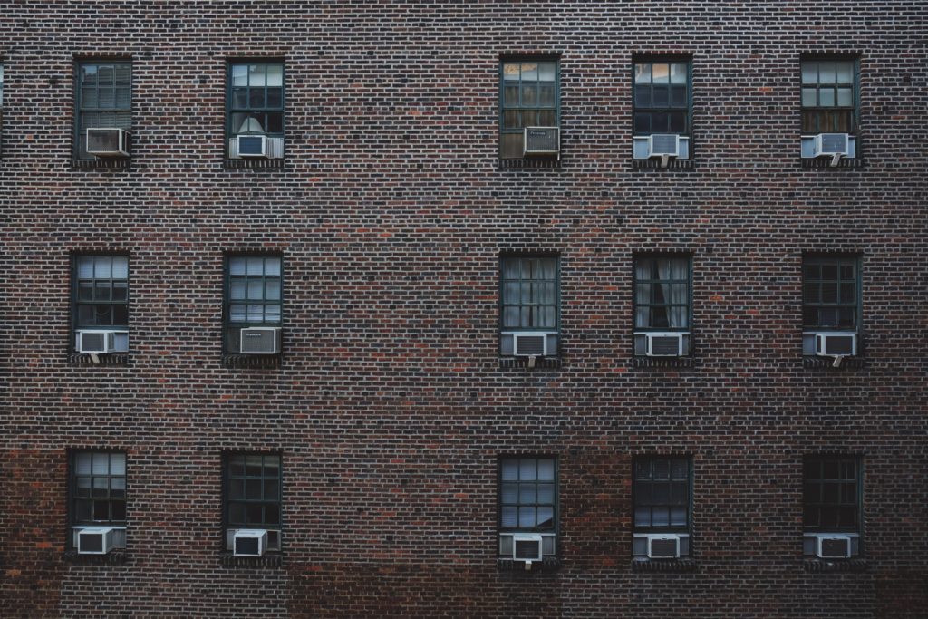 Prédio simples com muitas janelas e ar condicionados - Blog Viva de Pousada